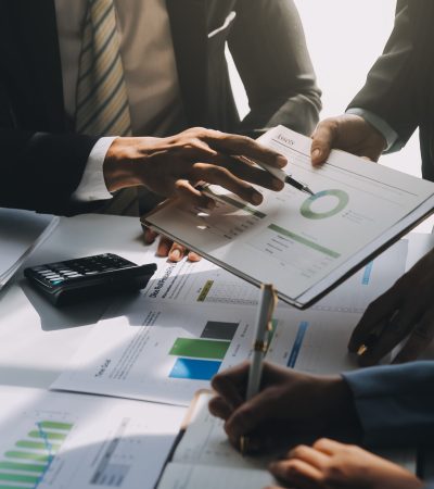 Business team meeting present, investor colleagues consultation and conference new strategy plan business and market growth on financial document graph report, Meeting and Talking.